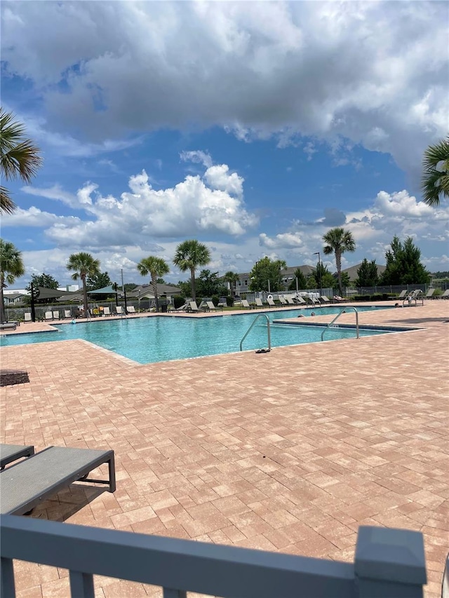 3240 Canna Lily Pl, Clermont, FL 34711 - community pool with a patio