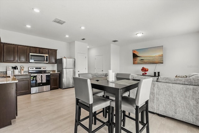 827 Grandin St, Davenport, FL 33837 - dining area featuring light wood finished floors and recessed lighting