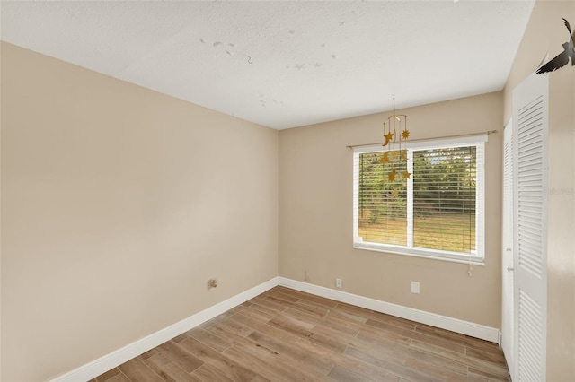 1000 Sal St, Ocoee, FL 34761 - empty room featuring a chandelier and wood finished floors