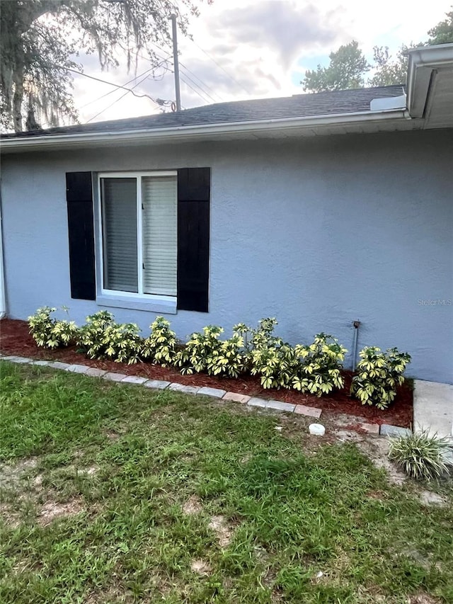 1000 Sal St, Ocoee, FL 34761 - view of property exterior featuring stucco siding and a yard