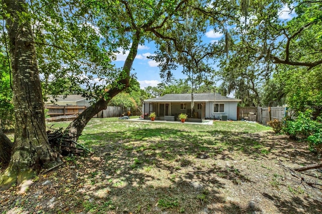 1000 Sal St, Ocoee, FL 34761 - back of property featuring a fenced backyard, a patio area, and a sunroom