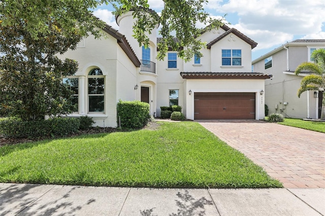 9207 Busaco Park Way, Winter Garden, FL 34787 - mediterranean / spanish house featuring driveway, stucco siding, and a front lawn