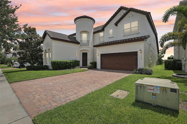9207 Busaco Park Way, Winter Garden, FL 34787 - mediterranean / spanish house featuring decorative driveway, a lawn, a garage, a tiled roof, and stucco siding