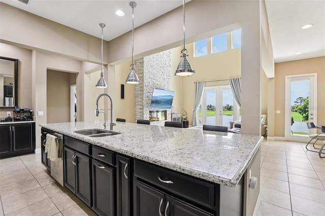 9207 Busaco Park Way, Winter Garden, FL 34787 - kitchen featuring dark cabinetry, light tile patterned floors, and a towering ceiling