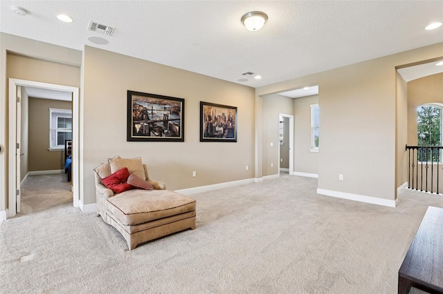 9207 Busaco Park Way, Winter Garden, FL 34787 - living area with light carpet, a textured ceiling, and recessed lighting