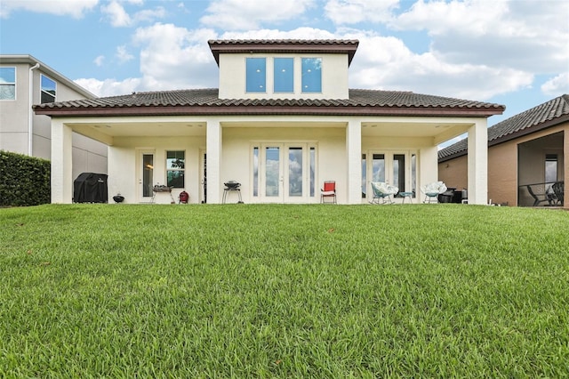 9207 Busaco Park Way, Winter Garden, FL 34787 - rear view of house with stucco siding, a lawn, and french doors
