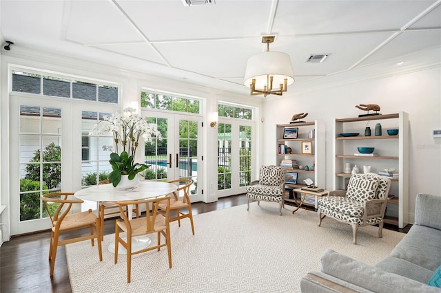 1011 Lake Davis Dr, Orlando, FL 32806 - dining space featuring french doors, dark wood-style flooring, a chandelier, and ornamental molding