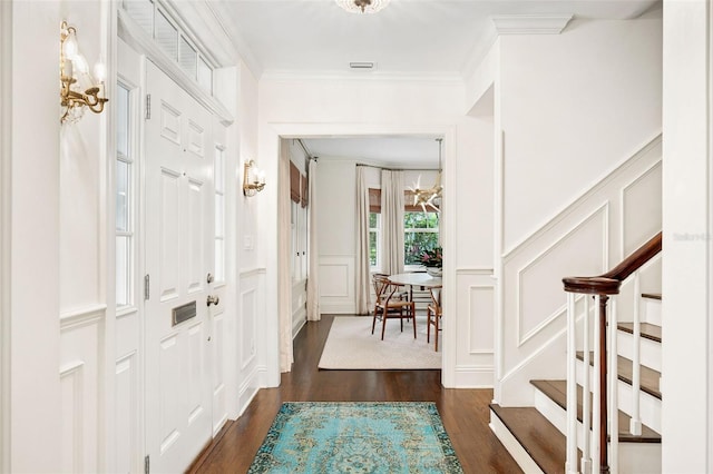 1011 Lake Davis Dr, Orlando, FL 32806 - entrance foyer with a decorative wall, dark wood-style floors, ornamental molding, stairs, and wainscoting
