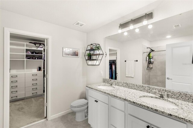 7603 Taormina Way, Clermont, FL 34714 - full bath with double vanity, a spacious closet, tiled shower, and tile patterned flooring