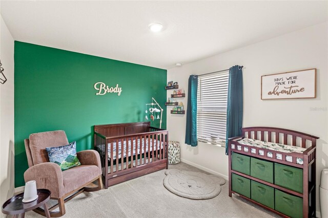 7603 Taormina Way, Clermont, FL 34714 - bedroom featuring an accent wall, carpet floors, and a nursery area