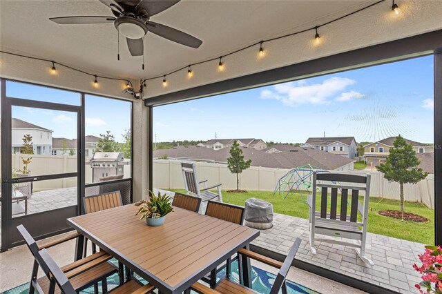 7603 Taormina Way, Clermont, FL 34714 - sunroom featuring a residential view, outdoor dining space, and ceiling fan