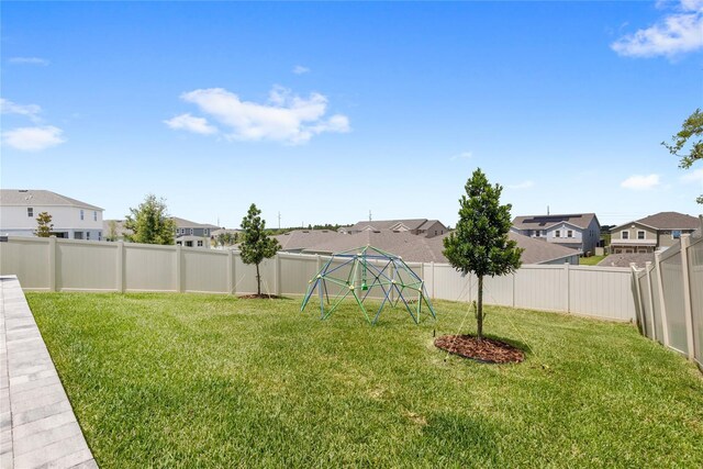 7603 Taormina Way, Clermont, FL 34714 - fenced backyard featuring a residential view and a playground