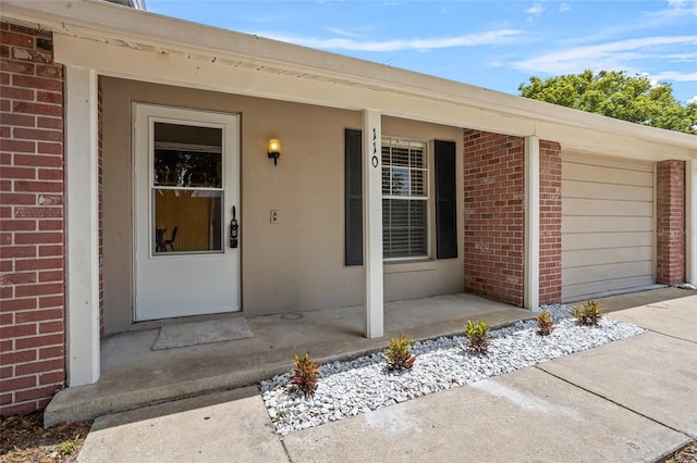 110 Rabun Ct, Sanford, FL 32773 - entrance to property with brick siding, a porch, and an attached garage