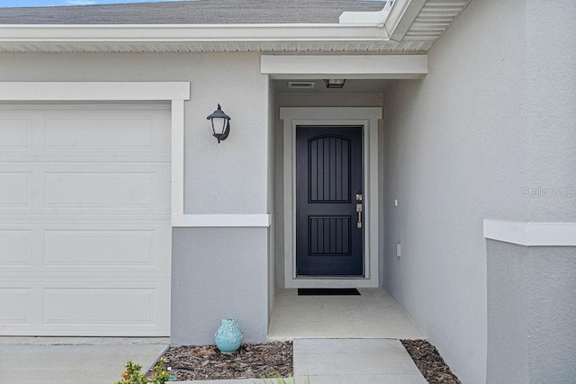 232 Summerlin Loop, Haines City, FL 33844 - property entrance featuring stucco siding and a garage