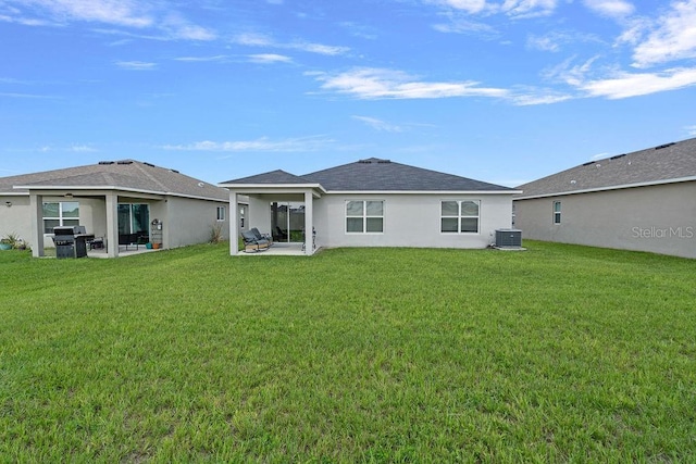 232 Summerlin Loop, Haines City, FL 33844 - rear view of house featuring a patio area, stucco siding, and a lawn