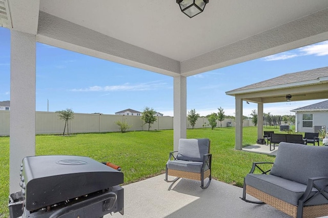 232 Summerlin Loop, Haines City, FL 33844 - fenced backyard with a patio area, outdoor lounge area, and a grill