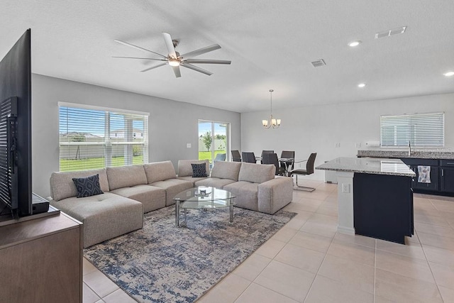 232 Summerlin Loop, Haines City, FL 33844 - living room featuring light tile patterned flooring, a ceiling fan, a chandelier, a textured ceiling, and recessed lighting