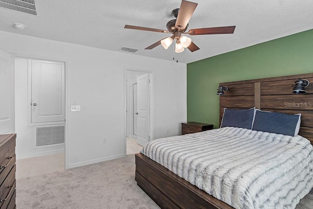 232 Summerlin Loop, Haines City, FL 33844 - bedroom with a ceiling fan, light colored carpet, light tile patterned floors, and a textured ceiling