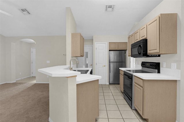 2404 SW 20th Ter, Ocala, FL 34471 - kitchen featuring black appliances, light brown cabinets, a peninsula, light countertops, and open floor plan