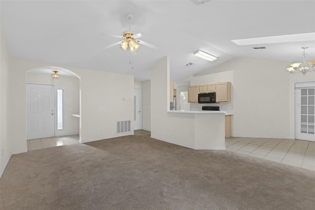 2404 SW 20th Ter, Ocala, FL 34471 - unfurnished living room featuring lofted ceiling, light carpet, light tile patterned flooring, arched walkways, and a chandelier