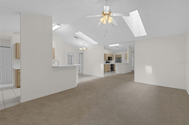 2404 SW 20th Ter, Ocala, FL 34471 - unfurnished living room featuring a skylight, light colored carpet, ceiling fan, vaulted ceiling, and a chandelier