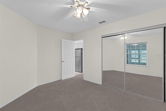 2404 SW 20th Ter, Ocala, FL 34471 - unfurnished bedroom with freestanding refrigerator, carpet, a closet, and a ceiling fan