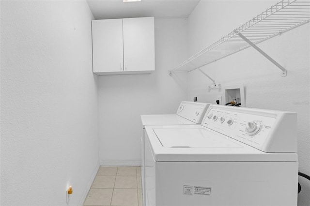2404 SW 20th Ter, Ocala, FL 34471 - laundry room featuring washing machine and dryer, light tile patterned floors, and cabinet space