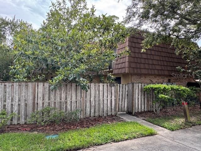 5302 Bamboo Ct Unit 447, Orlando, FL 32811 - view of side of property with brick siding and mansard roof
