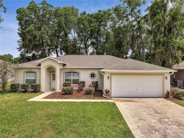 2823 NE 24th Pl, Ocala, FL 34470 - single story home featuring stucco siding, an attached garage, a front lawn, driveway, and roof with shingles