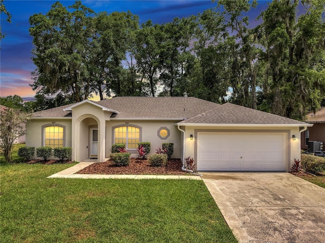 2823 NE 24th Pl, Ocala, FL 34470 - single story home with stucco siding, an attached garage, a front yard, concrete driveway, and roof with shingles