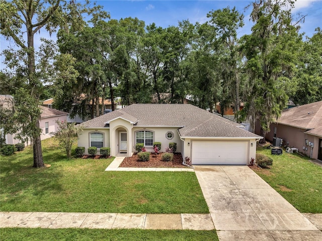 2823 NE 24th Pl, Ocala, FL 34470 - ranch-style house with an attached garage, a front yard, a shingled roof, concrete driveway, and stucco siding