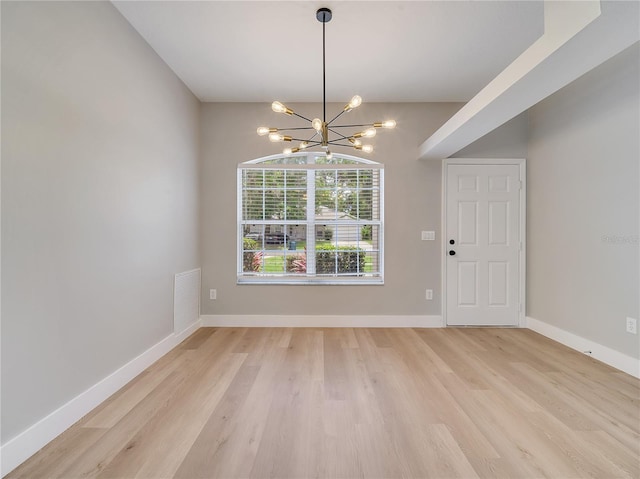 2823 NE 24th Pl, Ocala, FL 34470 - unfurnished dining area with a chandelier and light wood finished floors
