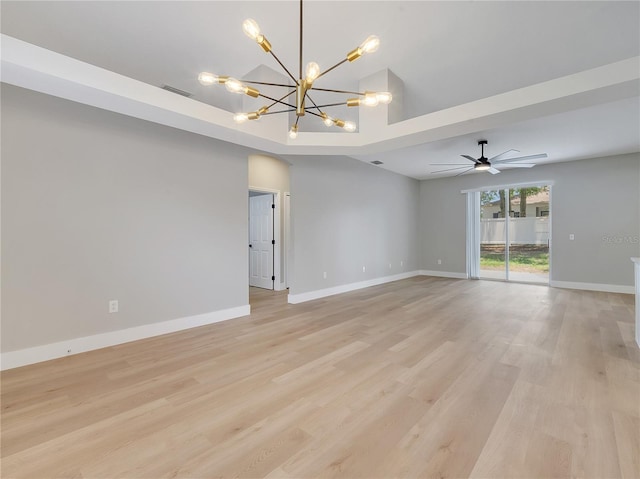 2823 NE 24th Pl, Ocala, FL 34470 - empty room with a chandelier, light wood-style floors, and a ceiling fan