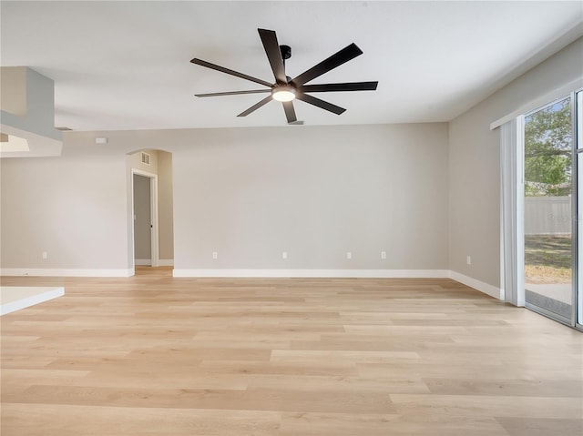 2823 NE 24th Pl, Ocala, FL 34470 - spare room featuring arched walkways, a ceiling fan, and light wood-style flooring