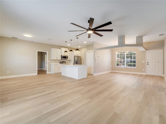2823 NE 24th Pl, Ocala, FL 34470 - unfurnished living room featuring ceiling fan, light wood-style flooring, and recessed lighting