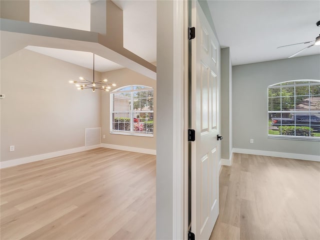 2823 NE 24th Pl, Ocala, FL 34470 - unfurnished room with light wood finished floors and a chandelier
