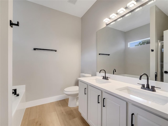2823 NE 24th Pl, Ocala, FL 34470 - full bathroom featuring a garden tub, wood finished floors, double vanity, and a shower stall