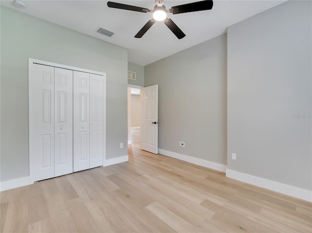 2823 NE 24th Pl, Ocala, FL 34470 - unfurnished bedroom with light wood finished floors, a closet, and a ceiling fan