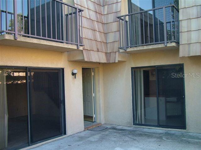 5327 Bamboo Ct Unit 426, Orlando, FL 32811 - property entrance featuring stucco siding, mansard roof, and a balcony