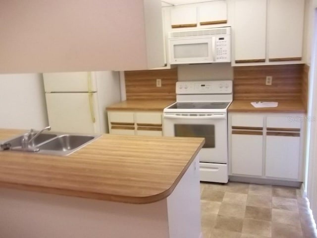 5327 Bamboo Ct Unit 426, Orlando, FL 32811 - kitchen featuring white appliances, white cabinets, and wood counters