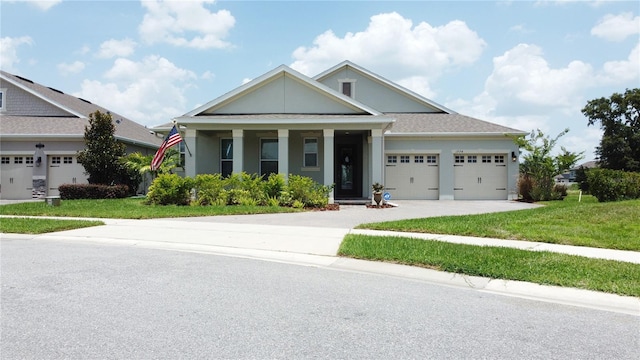 1774 Pasture Loop, Oviedo, FL 32765 - view of front of house with an attached garage, concrete driveway, a front lawn, and a porch