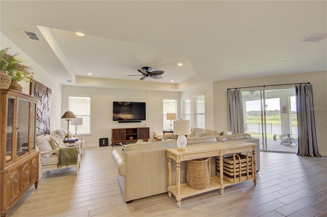 1774 Pasture Loop, Oviedo, FL 32765 - living room featuring a raised ceiling, ceiling fan, light wood-style flooring, plenty of natural light, and recessed lighting