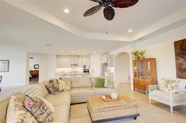 1774 Pasture Loop, Oviedo, FL 32765 - living area with arched walkways, ceiling fan, light wood-type flooring, recessed lighting, and a raised ceiling