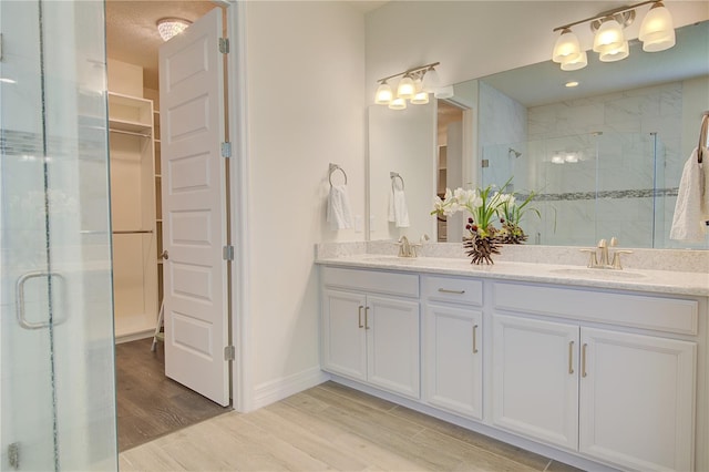 1774 Pasture Loop, Oviedo, FL 32765 - bathroom with a stall shower, double vanity, and wood finished floors