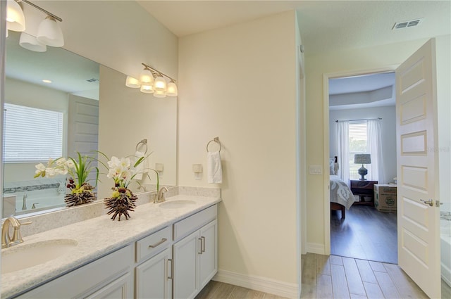 1774 Pasture Loop, Oviedo, FL 32765 - bathroom featuring ensuite bath, double vanity, wood finished floors, and a tub