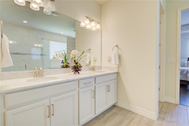 1774 Pasture Loop, Oviedo, FL 32765 - ensuite bathroom with double vanity, a marble finish shower, wood finished floors, and a chandelier