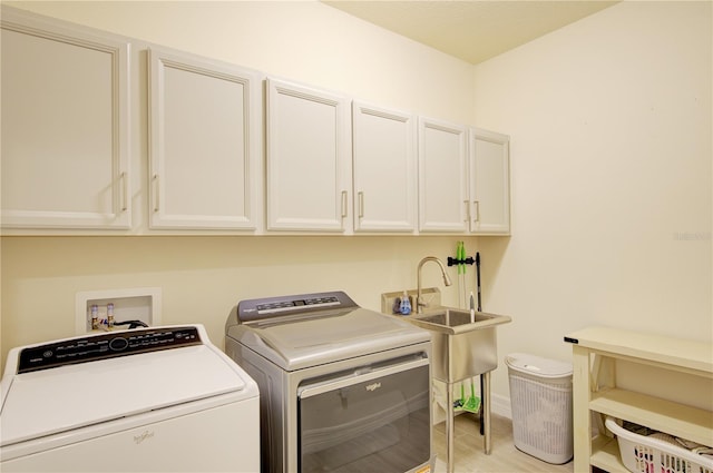 1774 Pasture Loop, Oviedo, FL 32765 - washroom featuring cabinet space, washing machine and dryer, and light wood-style flooring