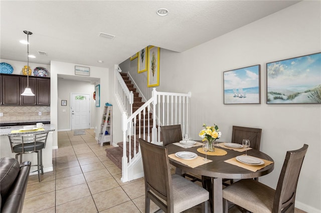 1909 Majorca Dr, Kissimmee, FL 34747 - dining area with stairway and light tile patterned floors