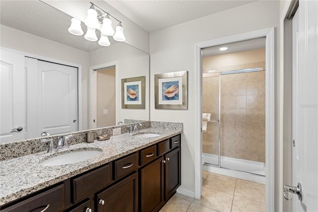 1909 Majorca Dr, Kissimmee, FL 34747 - bathroom featuring a stall shower, double vanity, tile patterned floors, and a chandelier