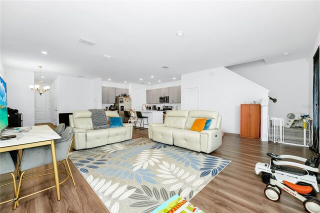 812 Benoi Dr, Davenport, FL 33896 - living room with a chandelier, wood finished floors, and recessed lighting